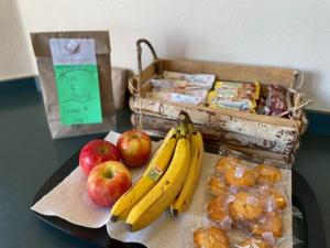 a table with bananas and apples and a box of snacks at Eagle Peak Lodge & Cabins in Ashton