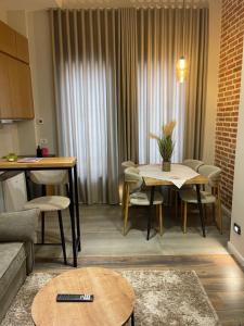a living room with a table and a kitchen at Liams Cozy Villa in Korçë +18 photos