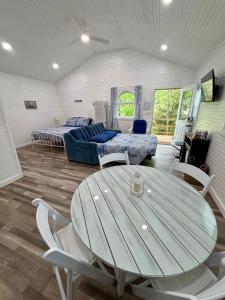 a room with a table and chairs and a bed at Romantic Tea Cottage with Deck and Nature in Cape Girardeau