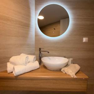 a bathroom with a sink and a mirror at Petra Studios in Palaiochora +70 photos