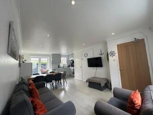 a living room with a couch and a dining room at Brighton Central Home with free parking in Brighton & Hove
