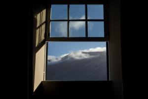an open window with a view of a mountain at Liiiving in Azores - Ocean View House in Canto da Areia