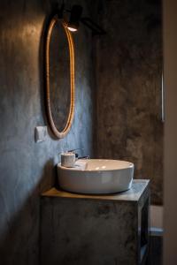 a bathroom with a sink and a mirror at Liiiving in Azores - Ocean View House in Canto da Areia