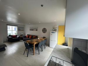 a kitchen and living room with a table and chairs at Brighton Central Home with free parking in Brighton & Hove