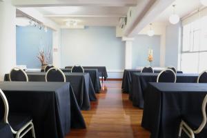 a conference room with black tables and chairs at Hotel Paola Antofagasta in Antofagasta