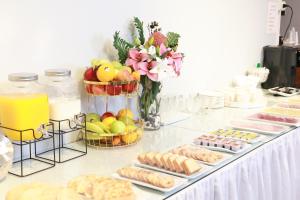 a buffet of food with cookies and fruit and drinks at Hotel Paola Antofagasta in Antofagasta