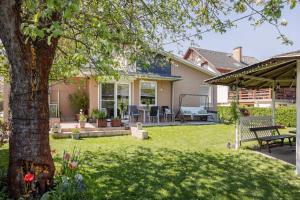 a yard with a tree and a swing at Riverside Apartman**** Miskolc in Miskolc