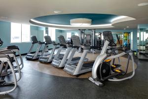 a gym with several treadmills and elliptical machines at Archer Hotel Austin in Austin