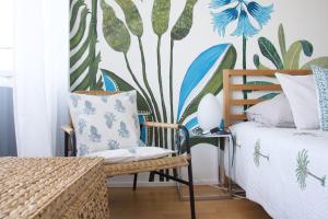 a bedroom with a bed and a plant wall at L'Effet Papillon - Maison d'hôtes in Sauges