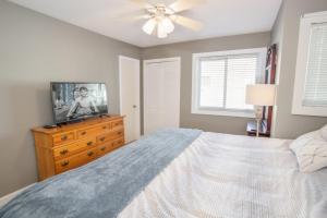 a bedroom with a bed and a television on a dresser at Condo at Pinnacle Inn Resort in Beech Mountain