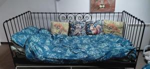 a bed with a blue blanket and pillows at Kingfisher Cottage Wales in Llanidloes