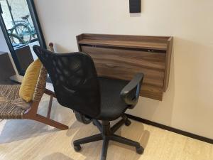 a black chair in front of a desk at Swim up pool Beachclub rooftop in Tulum +14 photos