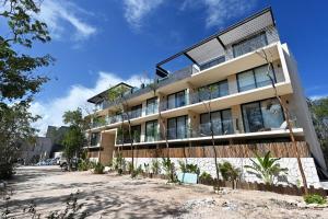 an apartment building with a lot of windows at Swim up pool Beachclub rooftop in Tulum