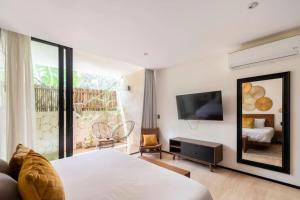 a bedroom with a bed and a large mirror at Swim up pool Beachclub rooftop in Tulum