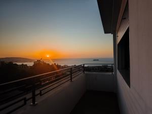 a view of the sunset from the balcony of a building at Malabata Gandori Familia Tanger in Tangier