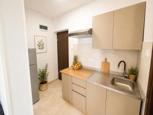 a kitchen with a sink and a counter top at Ap AS in Rogoznica