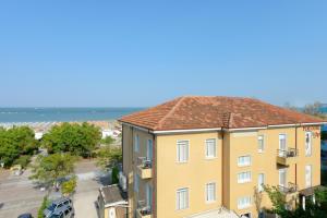 an apartment building with a view of the ocean at Hotel Flora in Cesenatico