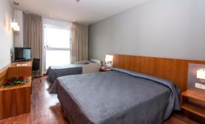 Postel nebo postele na pokoji v ubytování Hotel AG Express Elche
