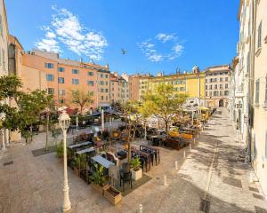 an empty street with tables and chairs and buildings at Studio Equerre in Toulon