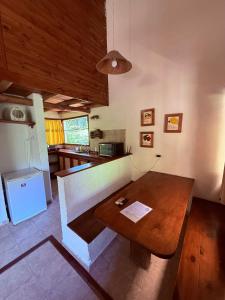 a kitchen with a wooden table and a refrigerator at Piedra Serrana in San Antonio de Arredondo