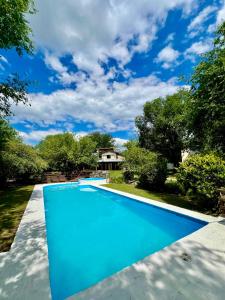 a swimming pool in a yard with a house at Piedra Serrana in San Antonio de Arredondo