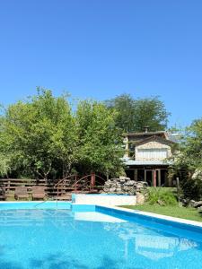 a swimming pool with a house in the background at Piedra Serrana in San Antonio de Arredondo +2 photos