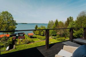 a balcony with a view of the water at Apartamenty Fuleda nad jeziorem Dobskim Mazury Holiday in Fuleda
