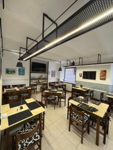 a dining room with wooden tables and chairs at Hotel Appennino in Sassoferrato