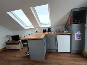 a kitchen with two skylights and a counter with a sink at Radharc soiléir in Doolin