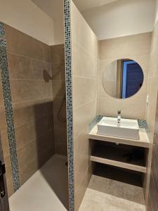 a bathroom with a sink and a shower at Appartements sur l'ile de Porquerolles in Porquerolles +35 photos