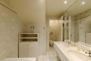 a bathroom with a tub and a sink and a toilet at Metropol Hotel in Calais +88 photos