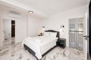 a white bedroom with a bed and a bathroom at Villa White Cloud in Dalyan +17 photos
