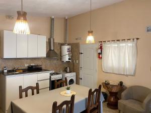 a kitchen with a table and a dining room at Casa Ayacucho in Alta Gracia