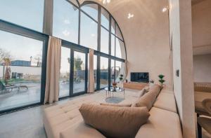 a large living room with a couch and large windows at KAYA PALACE SAPANCA in Sapanca