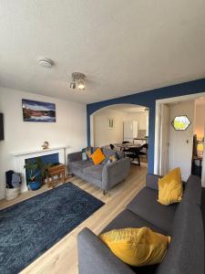 a living room with two couches and a fireplace at The Ship Inn's Cabin in Gatehouse of Fleet