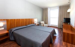 Postel nebo postele na pokoji v ubytování Hotel AG Express Elche