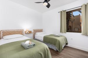 a room with two beds and a window at Casa Nube in Corralejo +17 photos