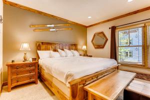 a bedroom with a large bed and a window at Jackpine & Black Bear Condos by Vail Resorts in Keystone +193 photos