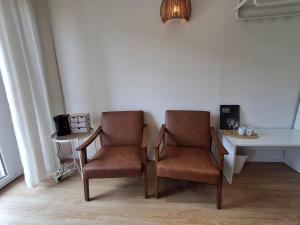 two chairs and a table in a room at B&B Haus Valmosa in Valwig