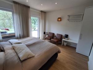 a bedroom with a large bed and a window at B&B Haus Valmosa in Valwig