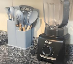 a black blender on a counter with a container of utensils at Joseph Prime Studio Hotel Extrema MG in Extrema