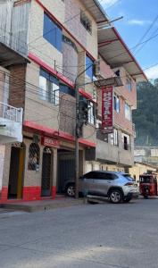 a car parked in front of a building at Hostal La Gata in Tingo María