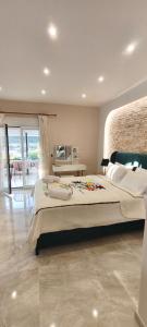 a large bedroom with a large bed and a balcony at Sea Salt Apartments in Samos