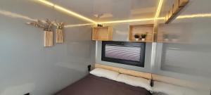 a small bedroom with a window in a tiny house at SEA & SOUL SUITe in El Puerto de Santa María