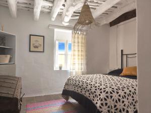 a bedroom with a bed and a window at Casa MANES in Pitres
