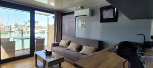 a living room with a couch and a large window at SEA & SOUL SUITe in El Puerto de Santa María +2 photos