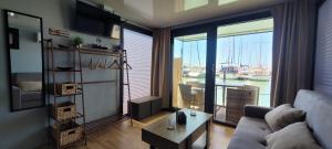 a living room with a couch and a view of a marina at SEA & SOUL SUITe in El Puerto de Santa María