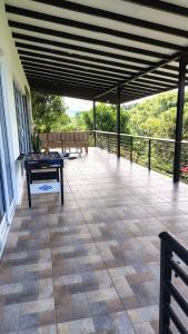 a patio with a table and chairs on a balcony at Finca Santa Rita in Pereira +1 photo