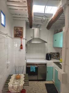 a small kitchen with a table and a stove at Casa MANES in Pitres