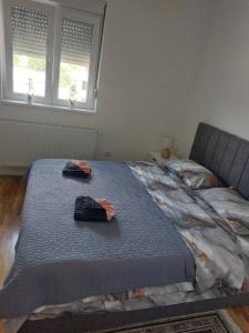 a bed in a room with two towels on it at Apartman 028 in Smederevska Palanka